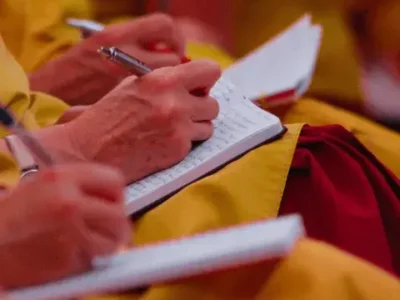 Dharma Study: Monks taking notes from a teaching
