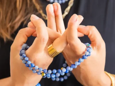 Chanted Buddhist Prayer: A person holding a Mala Beads whilst counting mantra in a prayer session