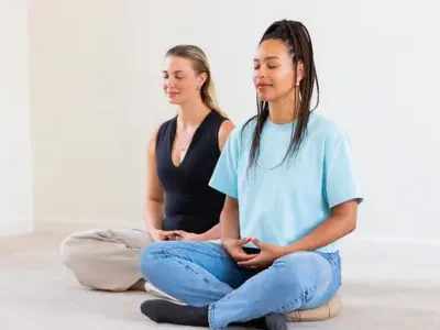 Two Women Meditating in a Meditation Centre