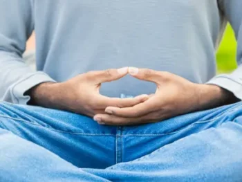 A man in a Meditation Lesson meditating with fingers in meditative poise