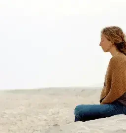 Person-Meditating-on-the-beach-1 Woman meditating on the beach