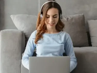 A Woman on a computer logging into the Friday Online Meditation Course